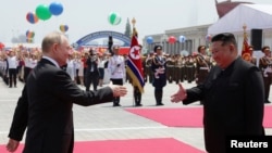 Президент Росії Володимир Путін (л) і лідер Північної Кореї Кім Чен Ин на офіційній церемонії зустрічі на площі Кім Ір Сена в Пхеньяні, Північна Корея, 19 червня 2024 року